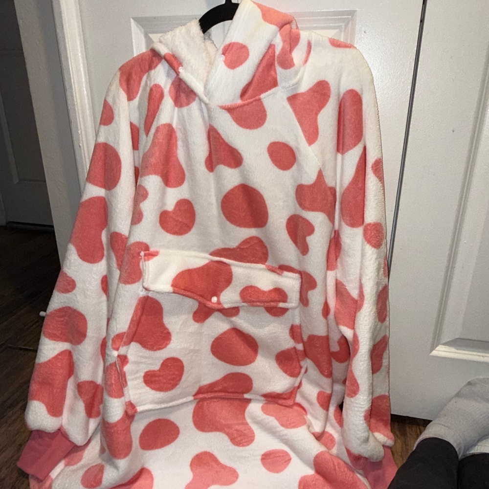 Oversized pink and white cow print hoodie with ears.